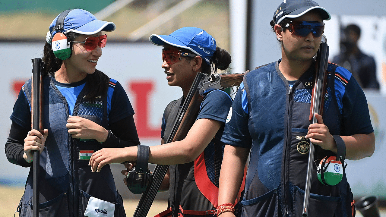 L-R) India's Rajeshwari Kumari, Manisha Keer and Shreyasi Singh are pictured after winning the women's trap team final of the ISSF World Cup 2021, at the Karni Singh Shooting Range in New Delhi. Credit: AFP Photo