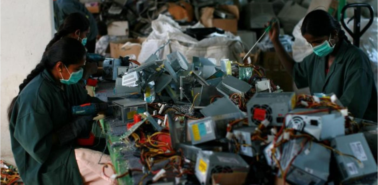Workers dismantle old computers and electronics at an electronic waste recycling factory in Dobbspet, 45 km from Bengaluru. Credit: Getty File Photo