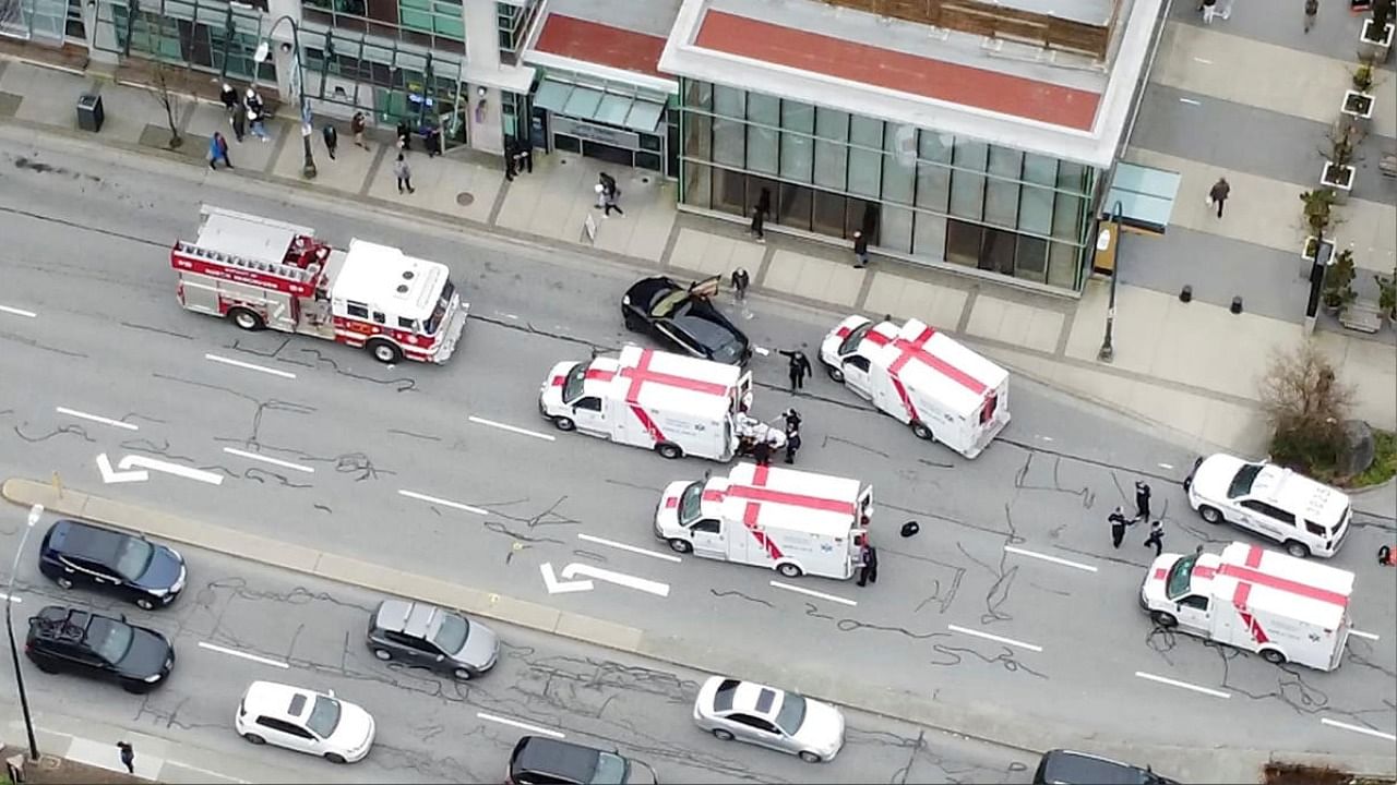 Ambulances and emergency personnel are seen on a road at Lynn Valley Plaza after a stabbing at a public library in a suburb in Vancouver, Canada March 27, 2021, in this still image from drone video obtained via social media. Credit: Andrew Cocking from SR Media Canada/Reuters.