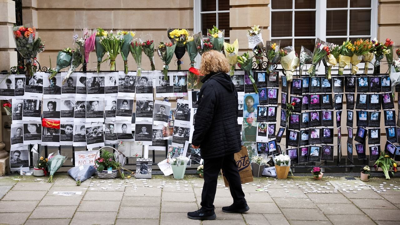 A person looks at tributes and protest signs outside the Embassy of Myanmar, in London, Britain, March 28, 2021. Credit: Reuters Photo