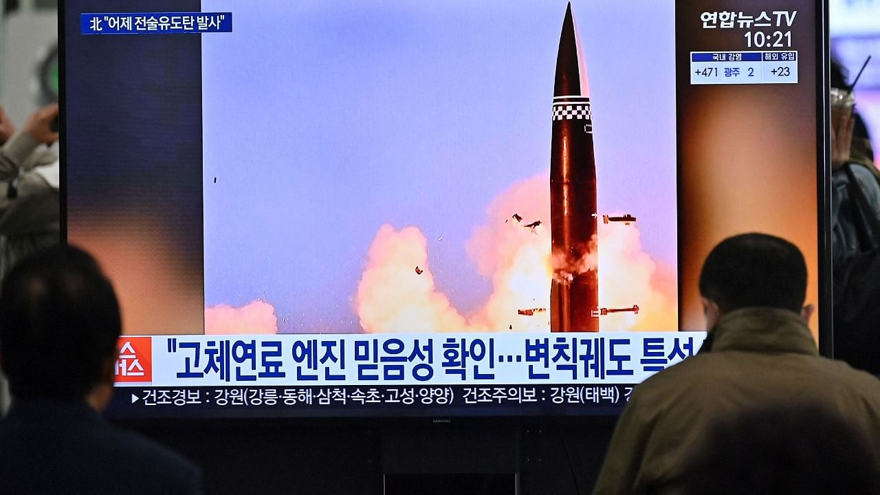 People watch a television screen at Suseo railway station in Seoul on March 26, 2021, showing news footage of North Korea's latest tactical guided projectile test. Credit: AFP Photo