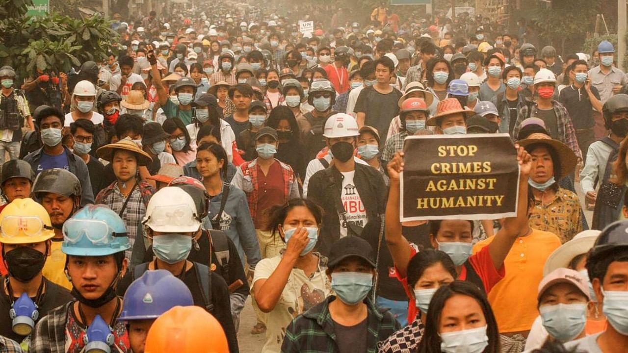 This photo taken and received from an anonymous source via Facebook on March 28, 2021 shows protesters taking part in a demonstration against the military coup in Monywa, Sagaing region. Credit: AFP Photo