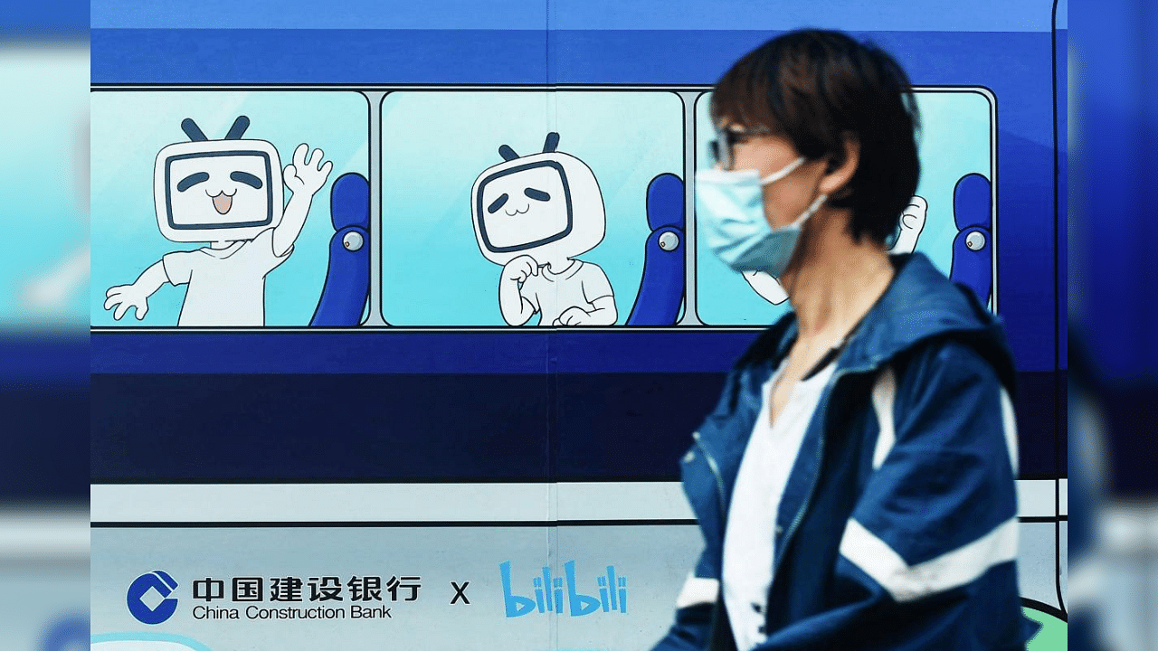 A pedestrian walks past images of the mascot and logo of video streaming site Bilibili in Hangzhou, China's eastern Zhejiang province, on March 29, 2021. Credit: AFP Photo