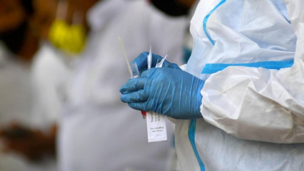 A healthcare worker prepares a Covid-19 testing kit in Bengaluru on March 27, 2021. Credit: DH Photo/PUSHKAR V