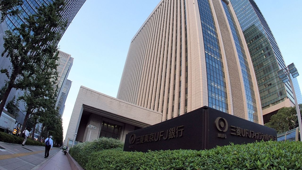 People walk beside the head quarters of Mitsubishi UFJ Financial Group, Inc in Tokyo. Credit: Getty.