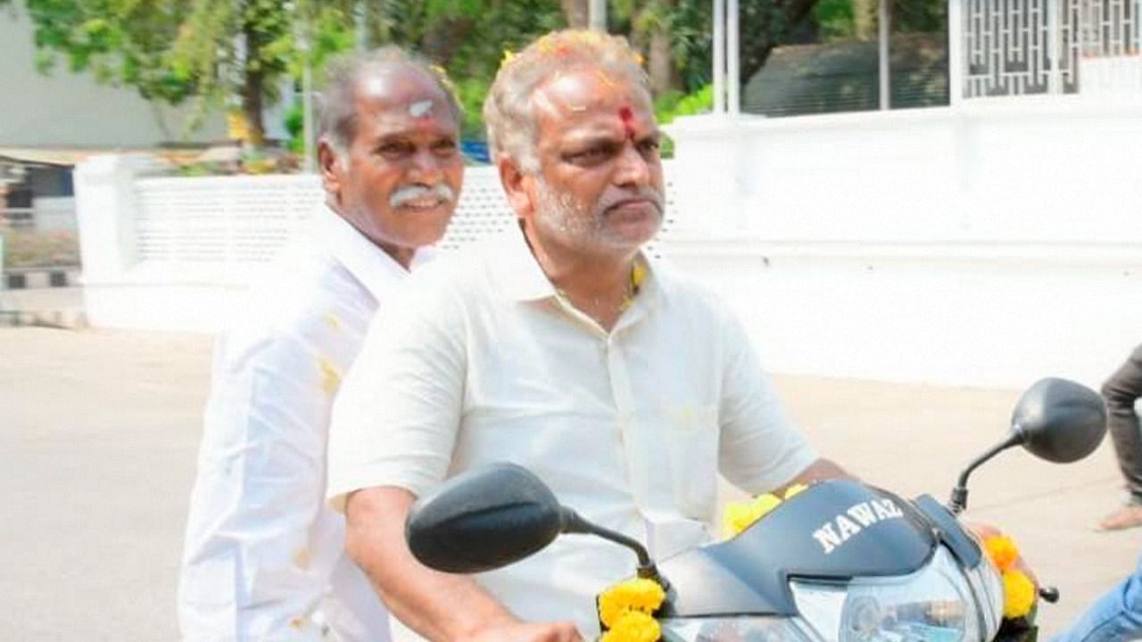 Former Chief Minister of Puducherry N Rangasamy rides pillion with former Health Minister Malladi Krishna Rao during All India NR Congress election campaign ahead of the Assembly elections, in Puducherry, Thursday, March 18, 2021. Credit: PTI File Photo