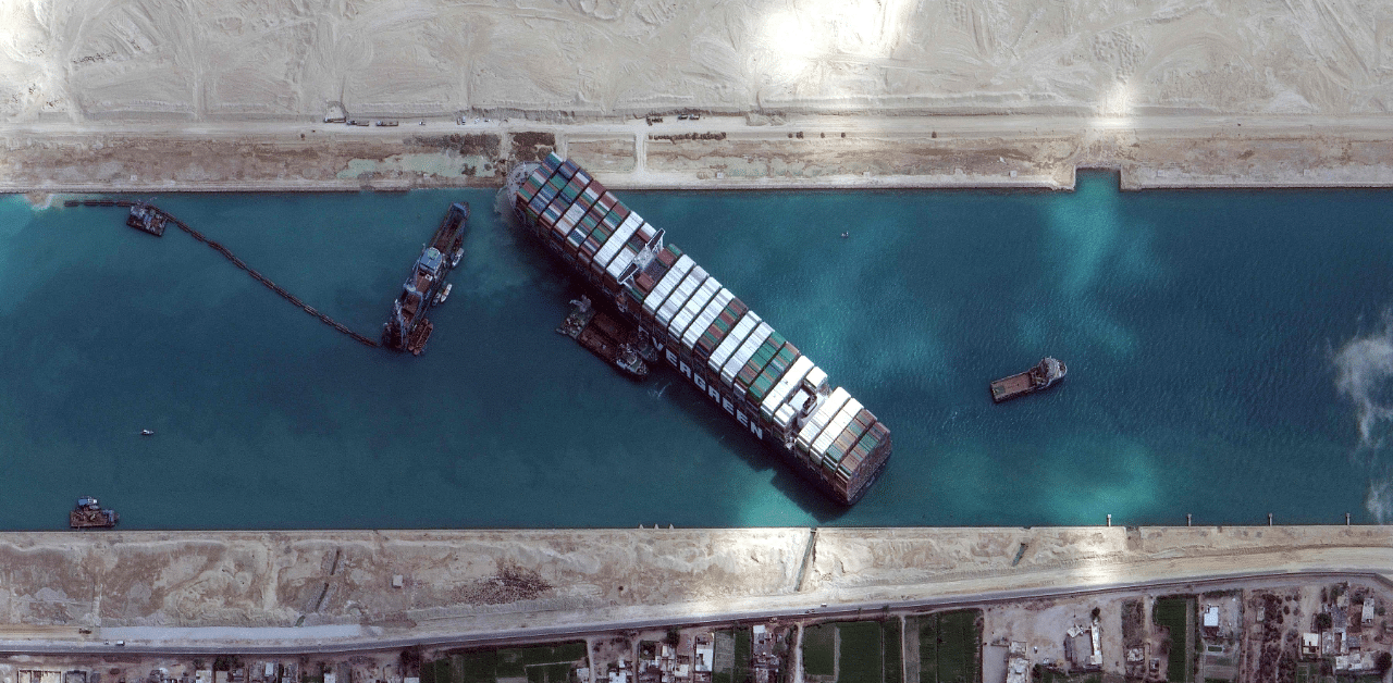 A container ship is wedged in the Suez Canal, blocking one of the most famous oil shipping routes, forcing mariners to take alternate routes. Credit: AFP Photo