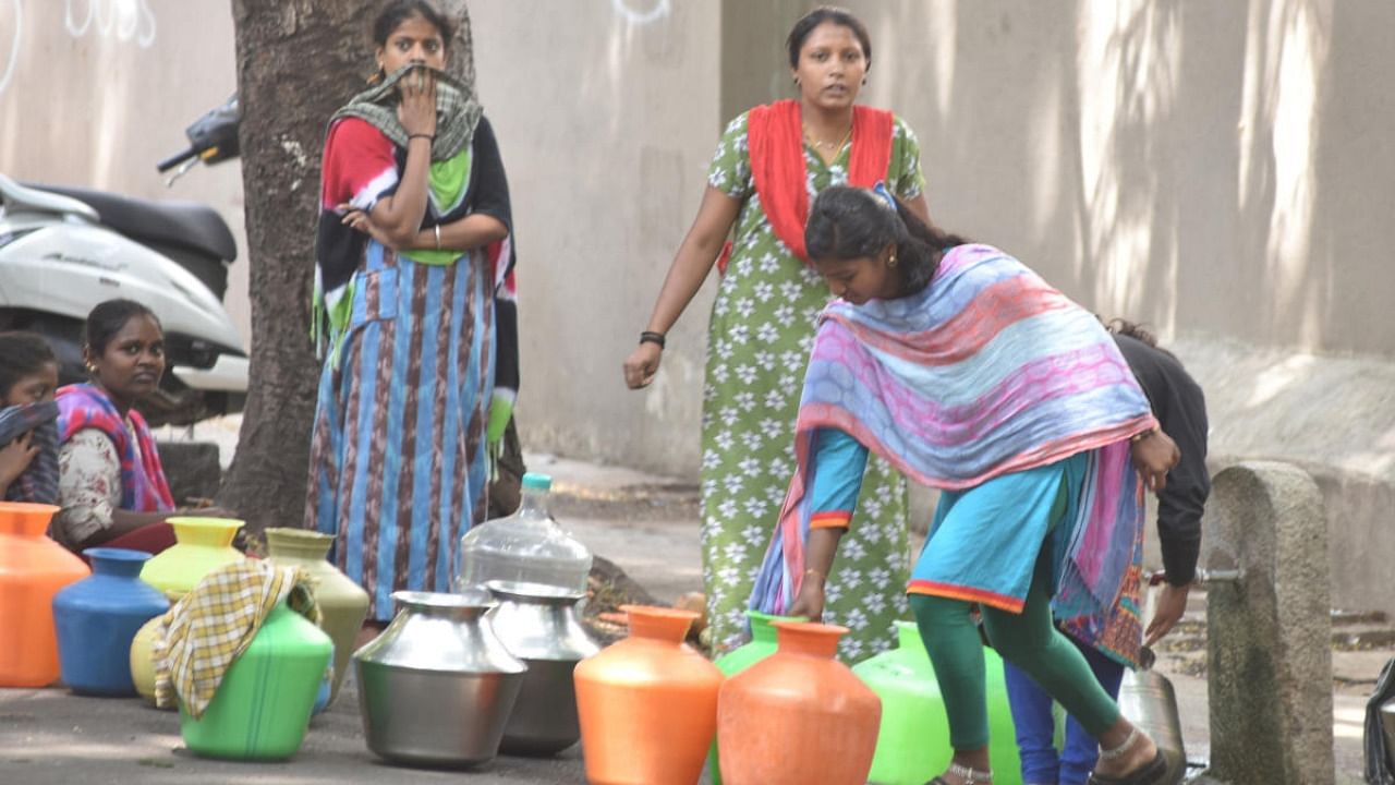 Women filling the water to pots from public water tap. Credit: DH file photo.