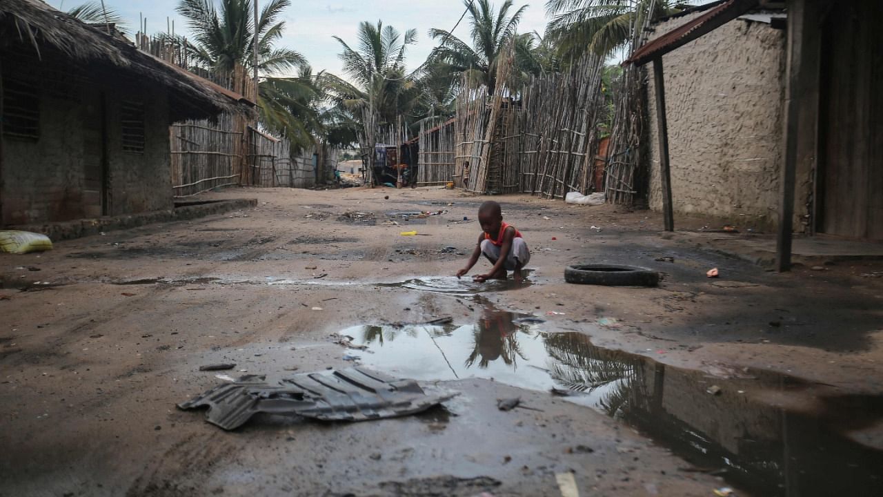 A child plays in one of the alleys of the port of Paquitequete near Pemba on March 29, 2021. Sailing boats are expected to arrive with people displaced from the coasts of Palma and Afungi after suffering attacks by armed groups since last March 24. Credit: AFP Photo