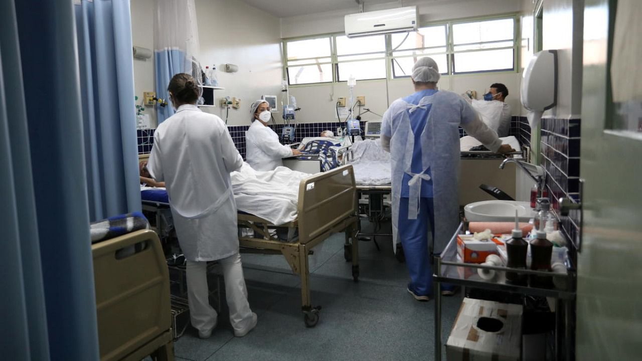 Health workers take care of patients, who tested positive for the coronavirus disease, as they wait to be transferred to the ICU in the Central Emergency Room in Bauru. Credit: Reuters.