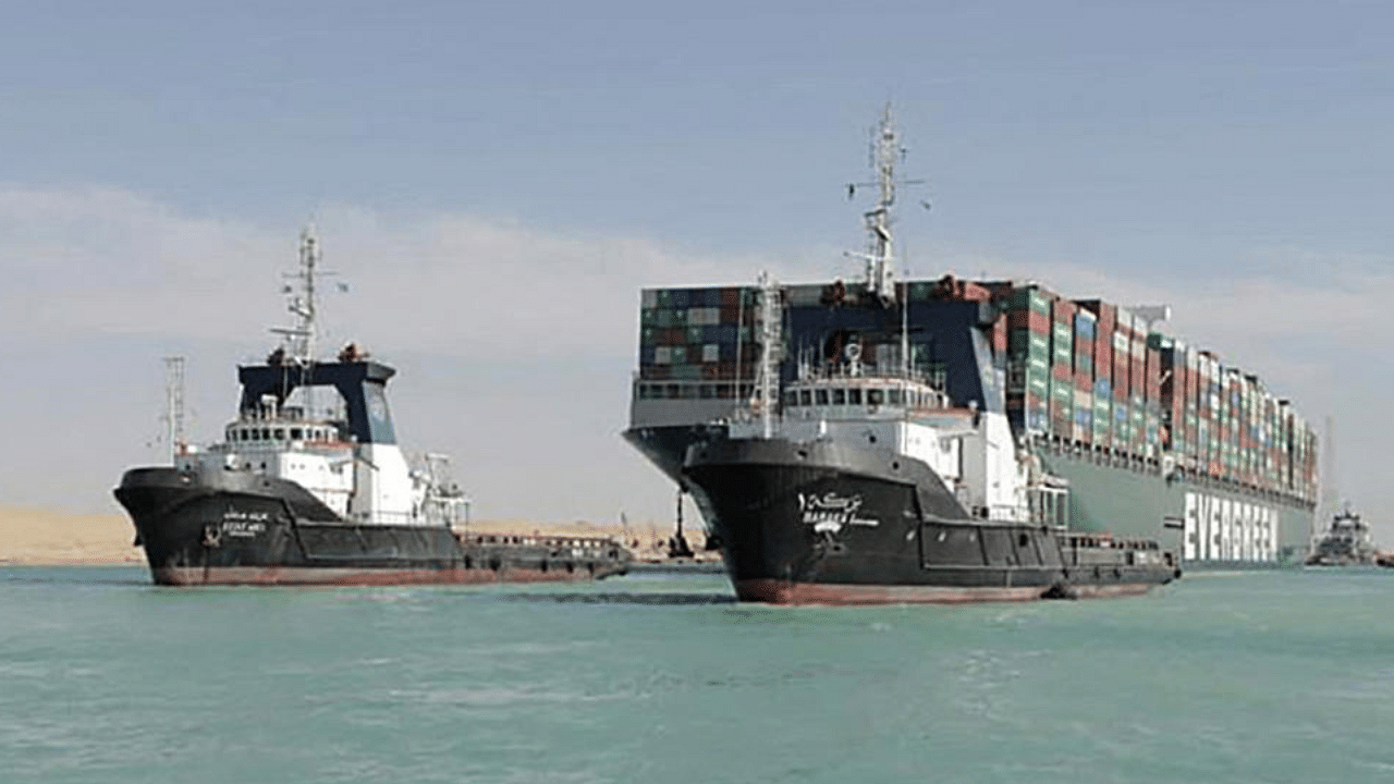 A picture released by Egypt's Suez Canal Authority on March 29, 2021, shows a tugboat pulling the Panama-flagged MV 'Ever Given' container ship after it was fully dislodged from the banks of the Suez. Credit: AFP Photo