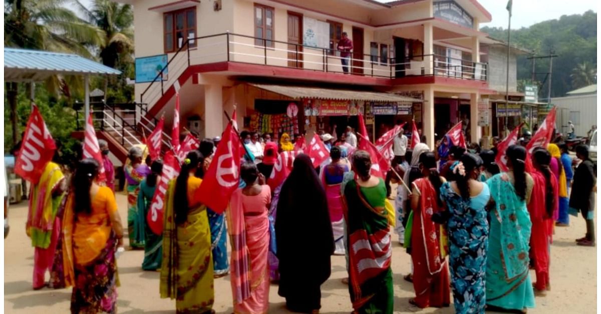 People under the aegis of the United Plantation Workers’ Union stage a protest in front of Madapura GP office. Credit: DH Photo