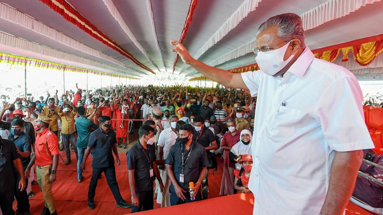 Kerala Chief Minister Pinarayi Vijayan greets party supporters during an election campaign ahead of Kerala Assembly Polls, in Thiruvananthapuram, Friday, March 26, 2021. Credit: PTI.
