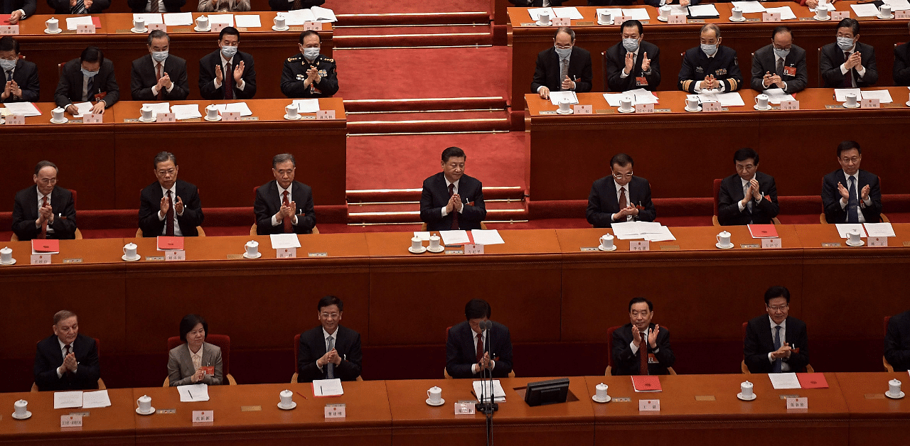 China's President Xi Jinping (C) applauding with other leaders and delegates after the result of the vote on changes to Hong Kong's election system. Credit: AFP Photo