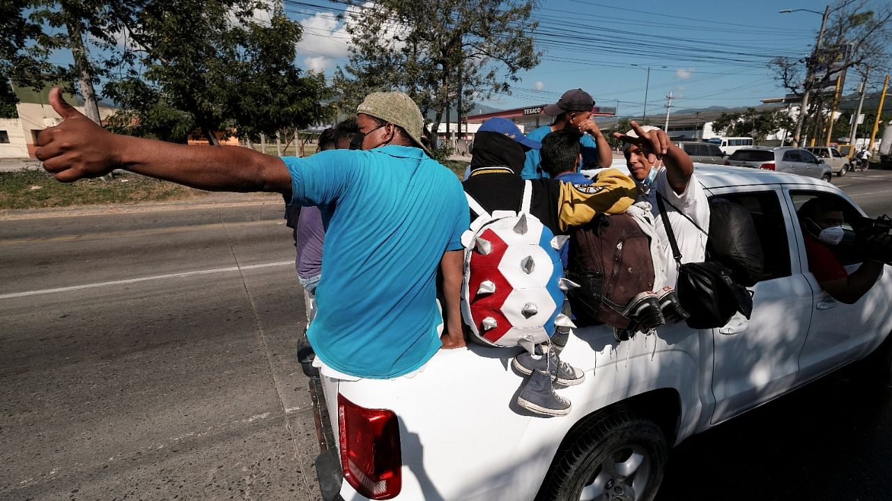 Hondurans ride in the back of a truck as they take part in a new caravan of migrants set to head to the US, in Choloma, Honduras March 30, 2021. Credit: Reuters Photo