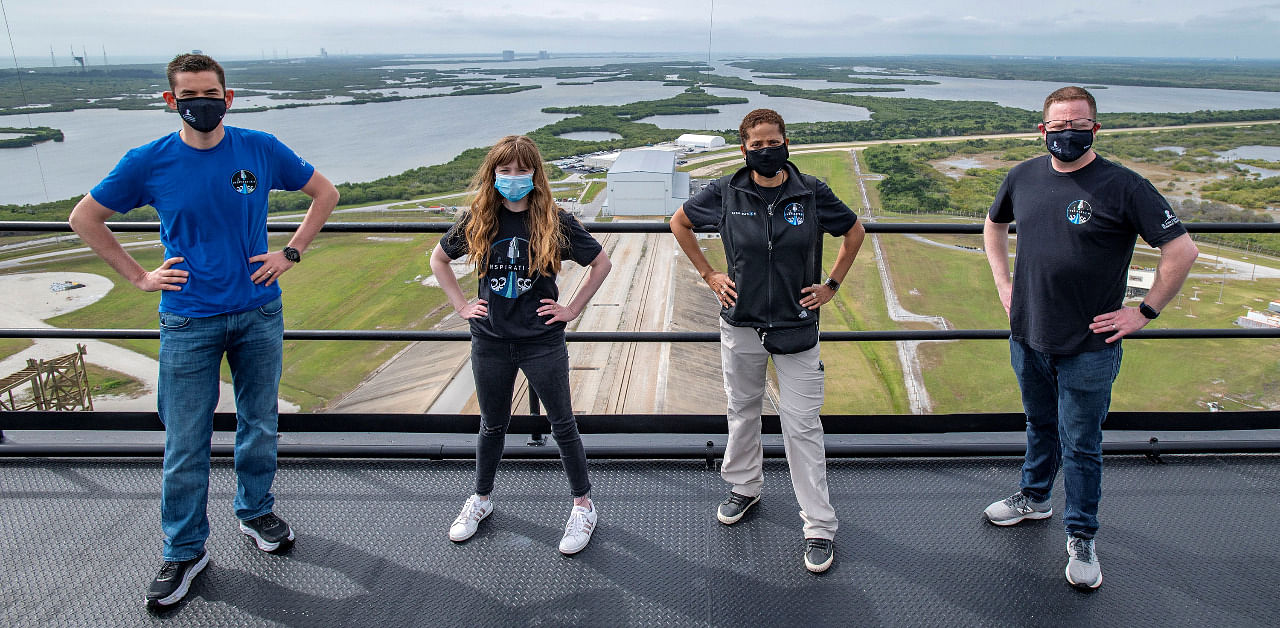 Jared Isaacman, Hayley Arceneaux, Sian Proctor and Chris Sembroski pose for a photo at the SpaceX launch tower at NASA's Kennedy Space Center. Credit: Reuters Photo
