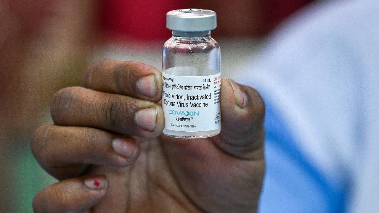 A medical worker displays a vial of the “Covaxin” the indigenous Covid-19 coronavirus vaccine during a routine inoculation drive at a vaccination center in New Delhi on March 23, 2021. Credit: AFP Photo