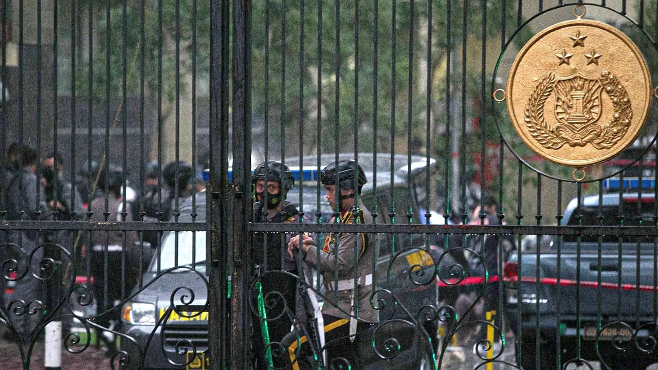 A police security team guard the entrance to the Indonesia National Police Headquarters in Jakarta after gunfire was heard in the compound. Credit: AFP Photo