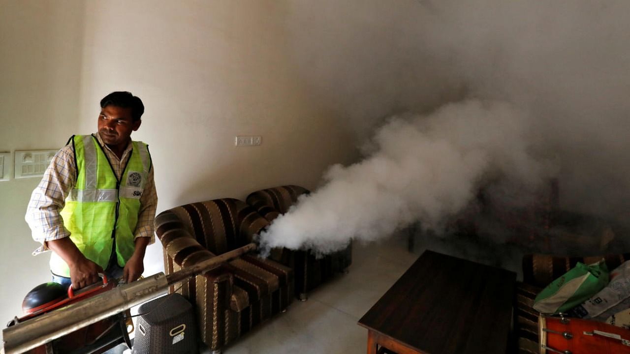A public health department worker fumigates inside a house to prevent the spread of mosquito borne diseases in New Delhi. Credit: Reuters file photo.