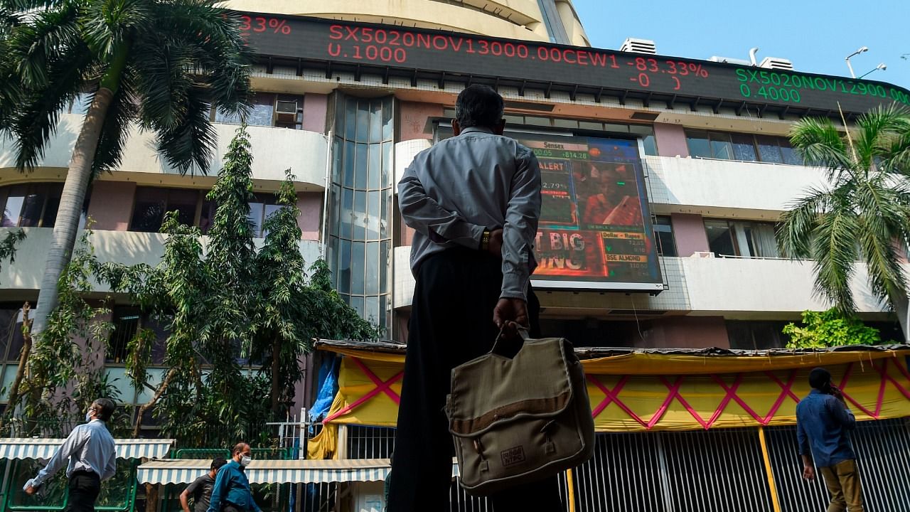 A pedestrian watches a digital screen relaying the budget speech by Indian Finance Minister Nirmala Sitharaman on the facade of the Bombay Stock Exchange (BSE) in Mumbai. Credit: AFP Photo