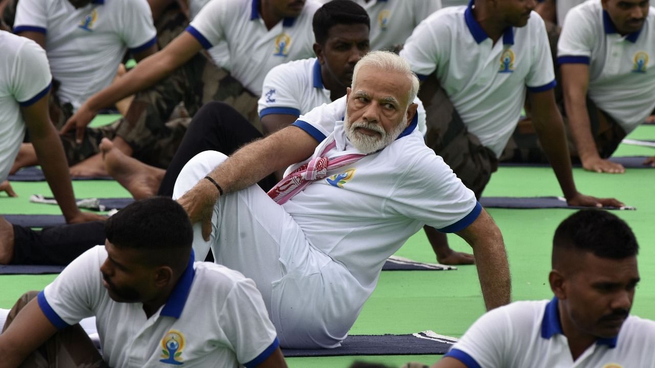 Prime Minister Narendra Modi performs yoga during a mass yoga event on International Yoga Day in Ranchi. Credit: AFP File Photo