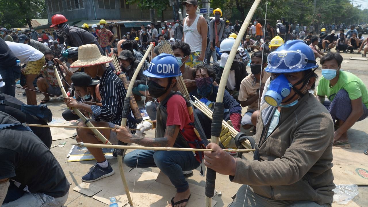 Anti-coup protesters prepare makeshift bow and arrows to confront police in Thaketa township Yangon, Myanmar, Saturday, March 27, 2021. Credit: AP/PTI Photo