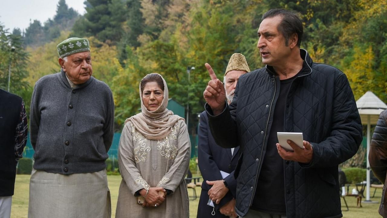 MP and President of National Conference (NC) Farooq Abdullah and PDP chief and former Chief Minister Mehbooba Mufti look on as People's Alliance for Gupkar Declaration spokesperson Sajjad Lone speaks to the media after a meeting of the Alliance. Credit: PTI File Photo