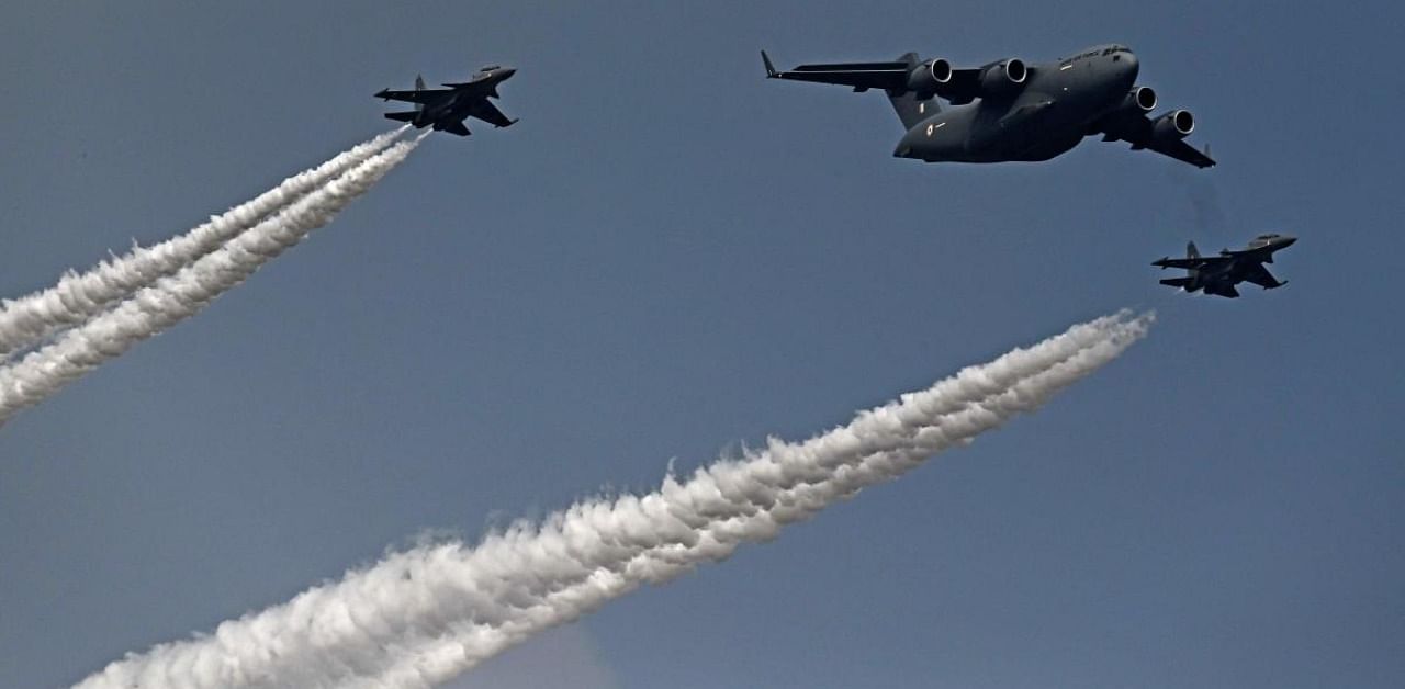 Indian Air Force's C-17 Globemaster (C) along with Sukhoi Su-30MKI fighter jets fly past during the first day of the Aero India 2021 Airshow at the Yelahanka Air Force Station in Bangalore on February 3, 2021. Credit: AFP Photo