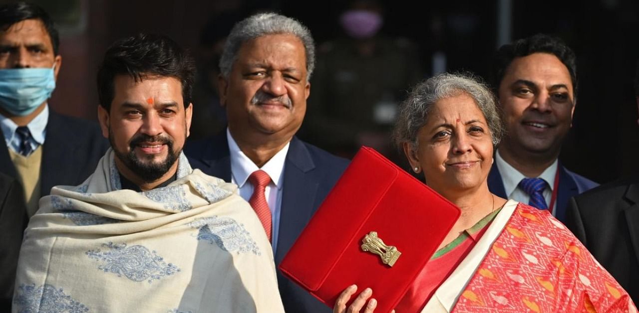 Finance Minister Nirmala Sitharaman (2R) along with her staff poses for pictures as she leaves the Finance Ministry to present the annual budget in parliament in New Delhi. Credit: AFP Photo