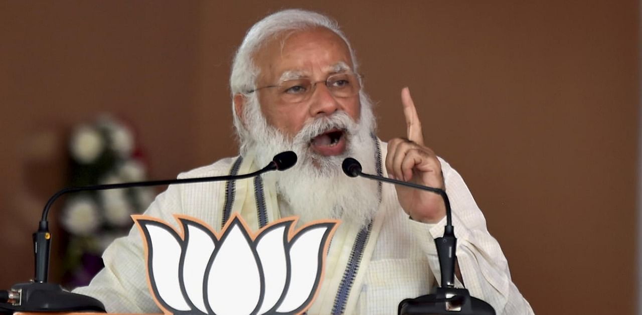  Prime Minister Narendra Modi addresses a public meeting as part of election campaign in support of their NDA alliance party candidates ahead of Tamil Nadu assembly polls, in Madurai. Credit: PTI Photo