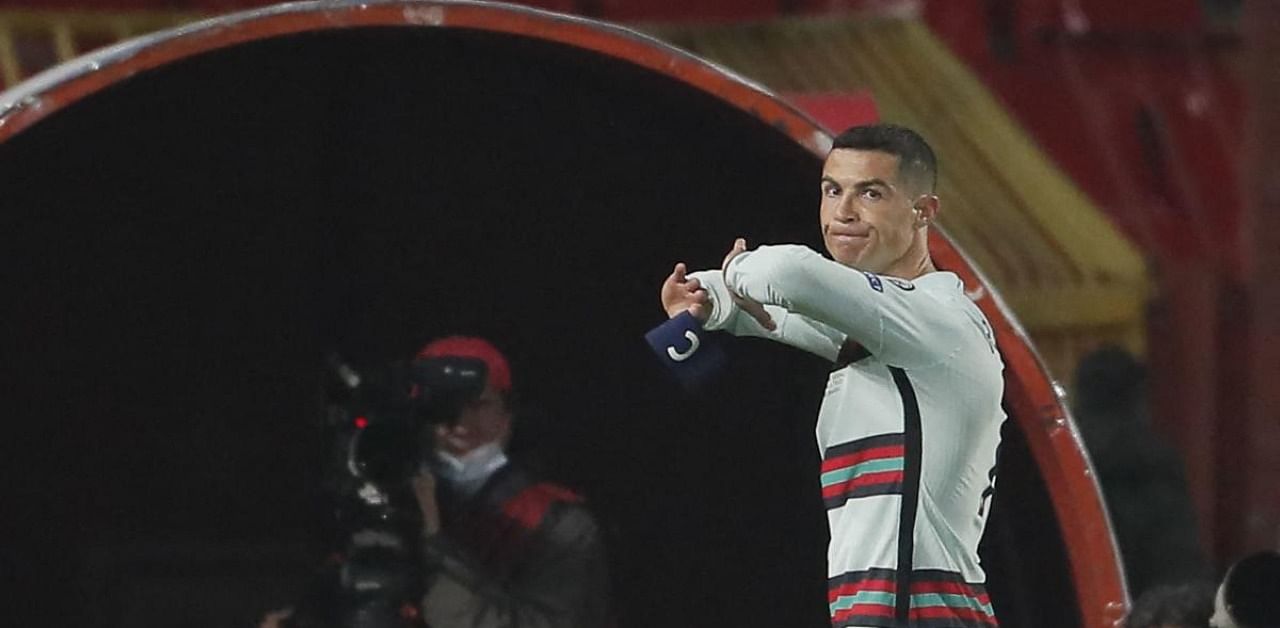 Cristiano Ronaldo holds his captain armband moments before he threw it to the ground. Credit: AFP Photo