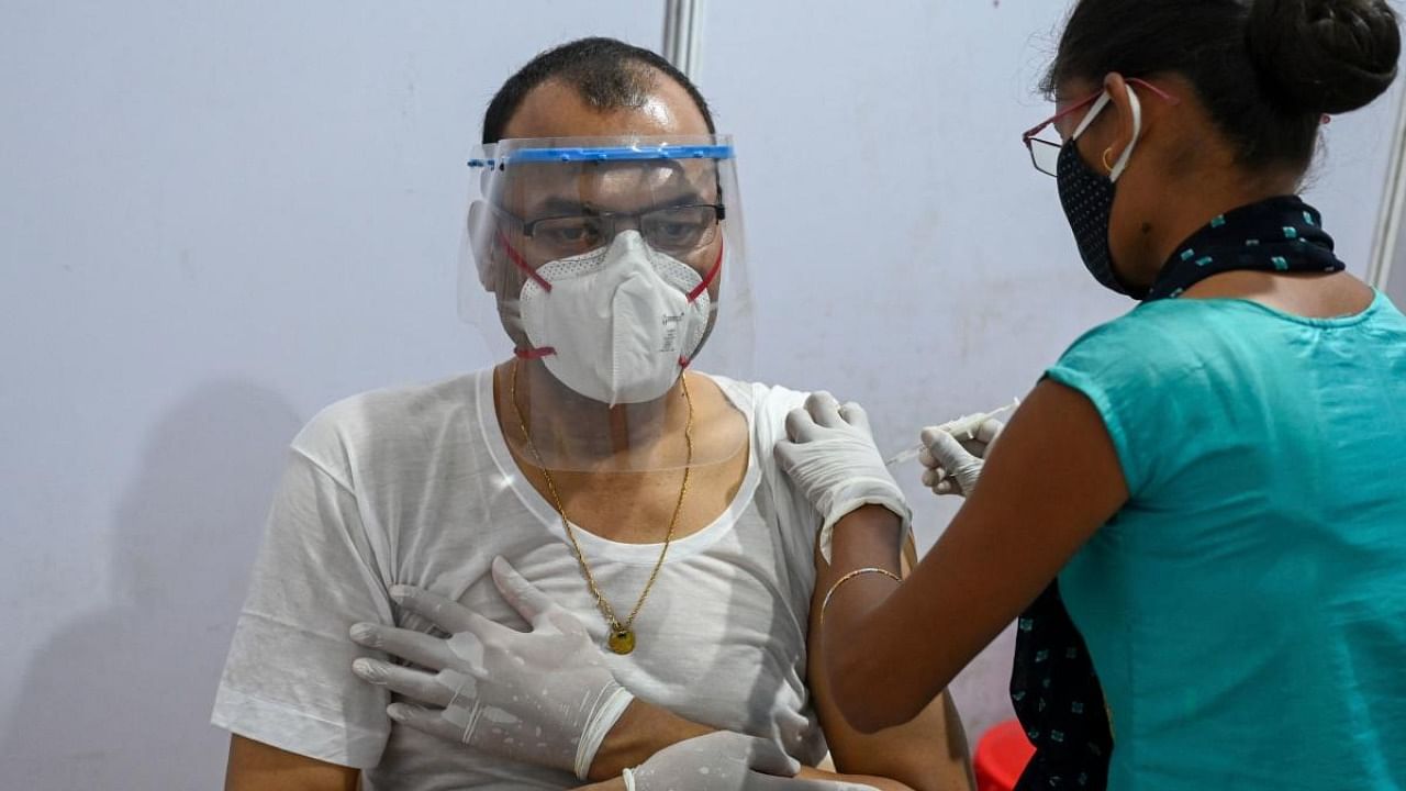 A man gets inoculated with a dose of the Covishield, AstraZeneca-Oxford's Covid-19 coronavirus vaccine, at a vaccination centre in Mumbai. Credit: AFP.