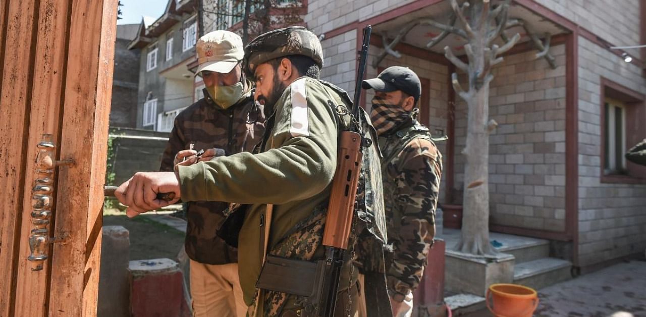 Police personnel examine the scene after the residence of BJP leader Anwar Ahmad Khan was attacked by alleged militants at Near Nowgam, in Srinagar, Thursday, April 1, 2021. Credit: PTI Photo