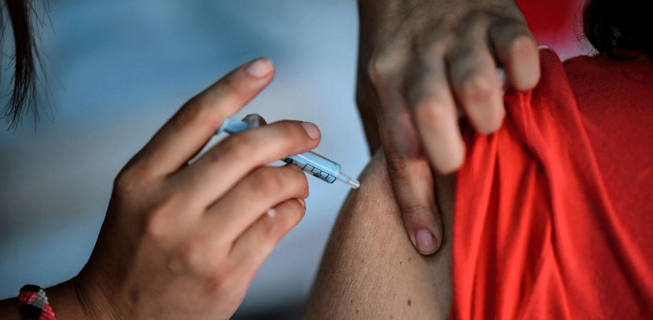 A health worker applies a dose of the Sputnik V vaccine against Covid-19, at the Centenario stadium in Quilmes, Buenos Aires province. Credit: AFP photo. 