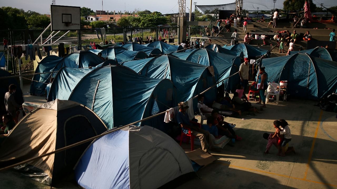 Venezuelan migrants are seen inside a coliseum where a temporary camp has been set up, after fleeing their country due to military operations. Credit: Reuters Photo
