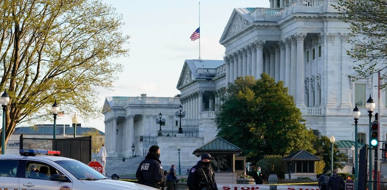 The US flag at the Capitol flies at half-staff to honor Officer William Evans who was killed in Friday's attack. Credit: AP Photo