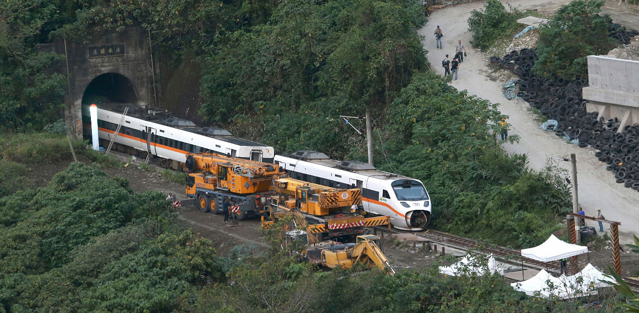Rescue workers remove a part of the derailed train near Taroko Gorge in Hualien, Taiwan. Credit: AP Photo