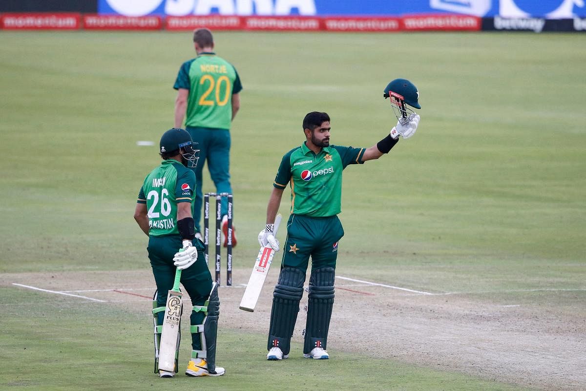 Pakistan's captain Babar Azam (R) celebrates after scoring a century (100 runs) during the first one-day international (ODI) cricket match between South Africa and Pakistan at SuperSport Park in Centurion. Credit: AFP photo. 