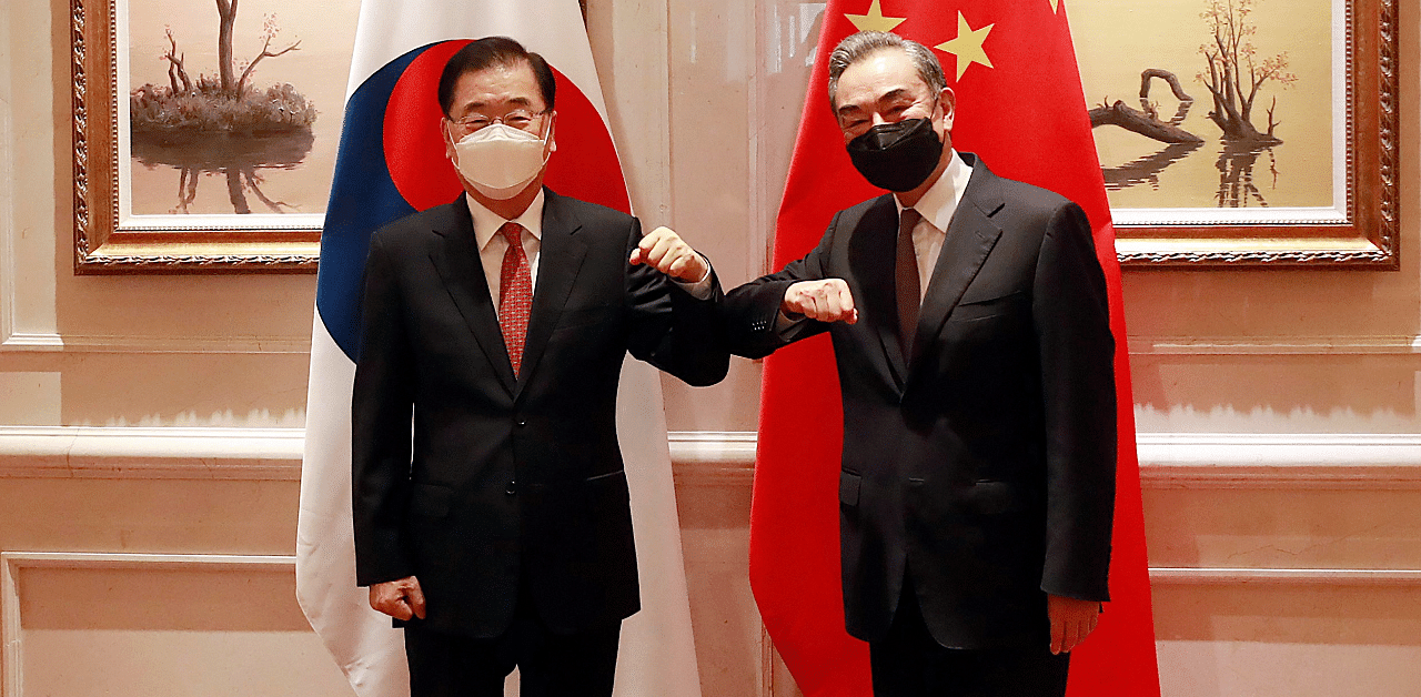 South Korean Foreign Minister Chung Eui-yong, left, and Chinese Foreign Minister Wang Yi bump elbows prior to their meeting in Xiamen, China. Credit: AP Photo