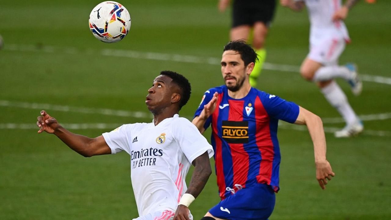 Eibar's Portuguese defender Paulo Oliveira (R) challenges Real Madrid's Brazilian forward Vinicius Junior during the Spanish League football match between Real Madrid CF and SD Eibar at the Alfredo di Stefano stadium in Valdebebas on the outskirts of Madrid. Credit: AFP.