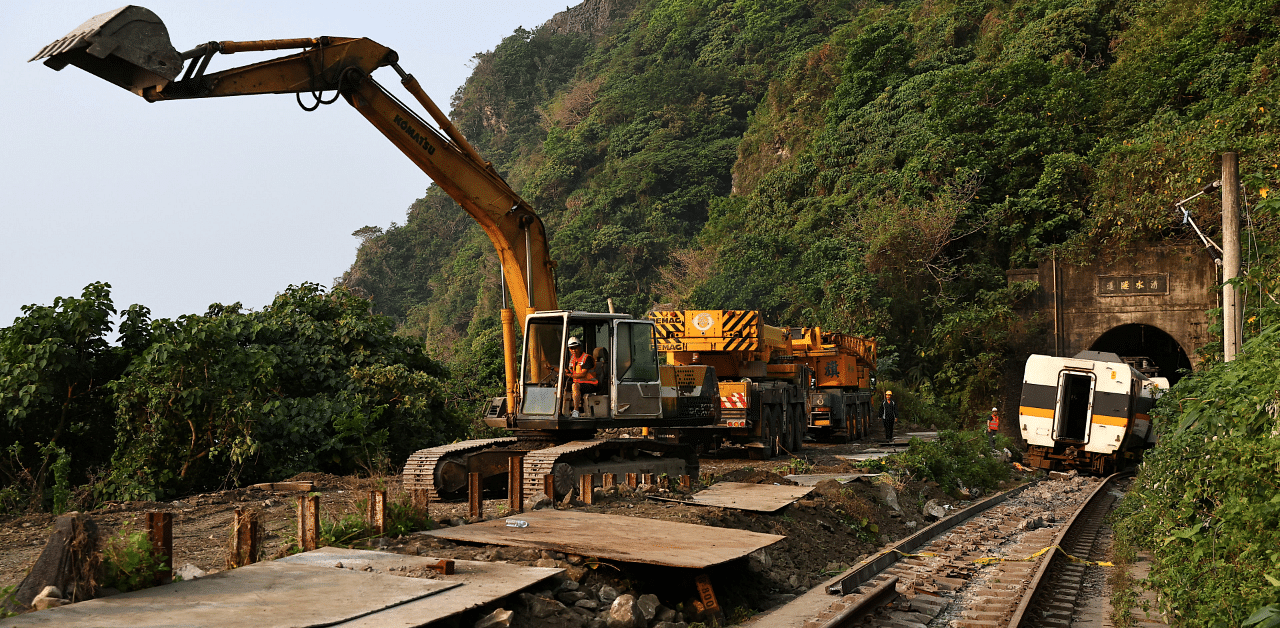 Rescuers work at the site a day after a deadly train derailment at a tunnel north of Hualien. Credit: Reuters Photo