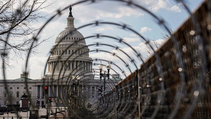 The US Capitol is seen through razor wire. Credit: Reuters photo. 