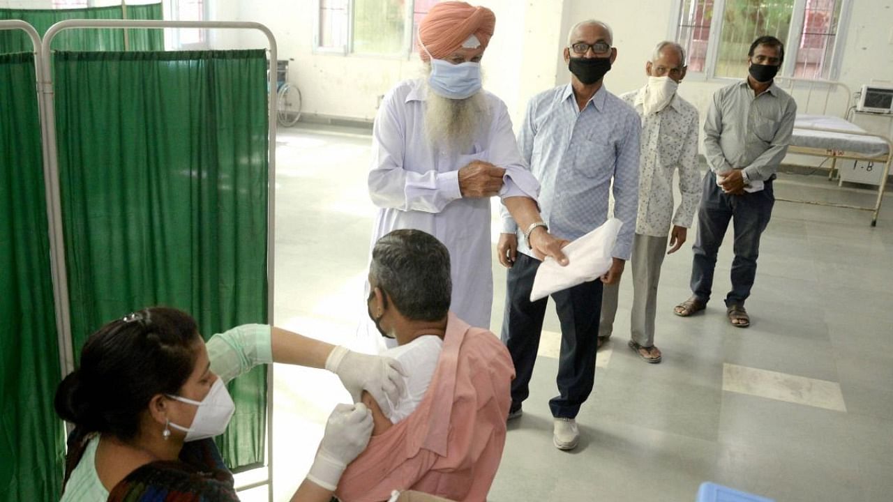 A medic administers a Covid-19 vaccine at a government hospital in Jalandhar. Credit: PTI Photo