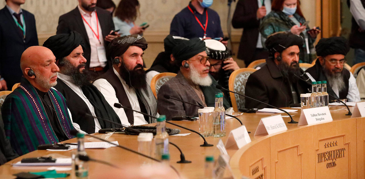 Former President Hamid Karzai, left, and Taliban co-founder Mullah Abdul Ghani Baradar, second right, attend an international peace conference in Moscow, Russia. Credit: AP Photo