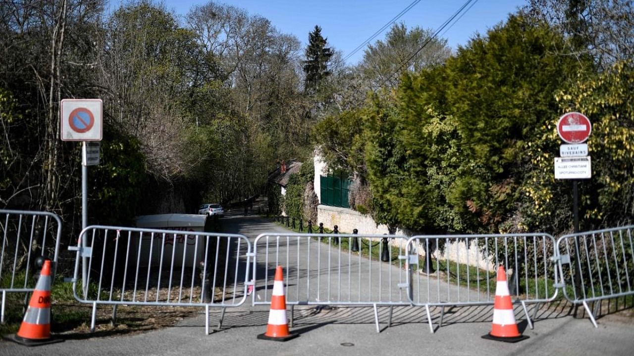 Police officers cordon-off the area near the house of French businessman Bernard Tapie and his wife Dominique Tapie in Combs-la-Ville, southeastern suburbs of Paris. Credit: AFP.