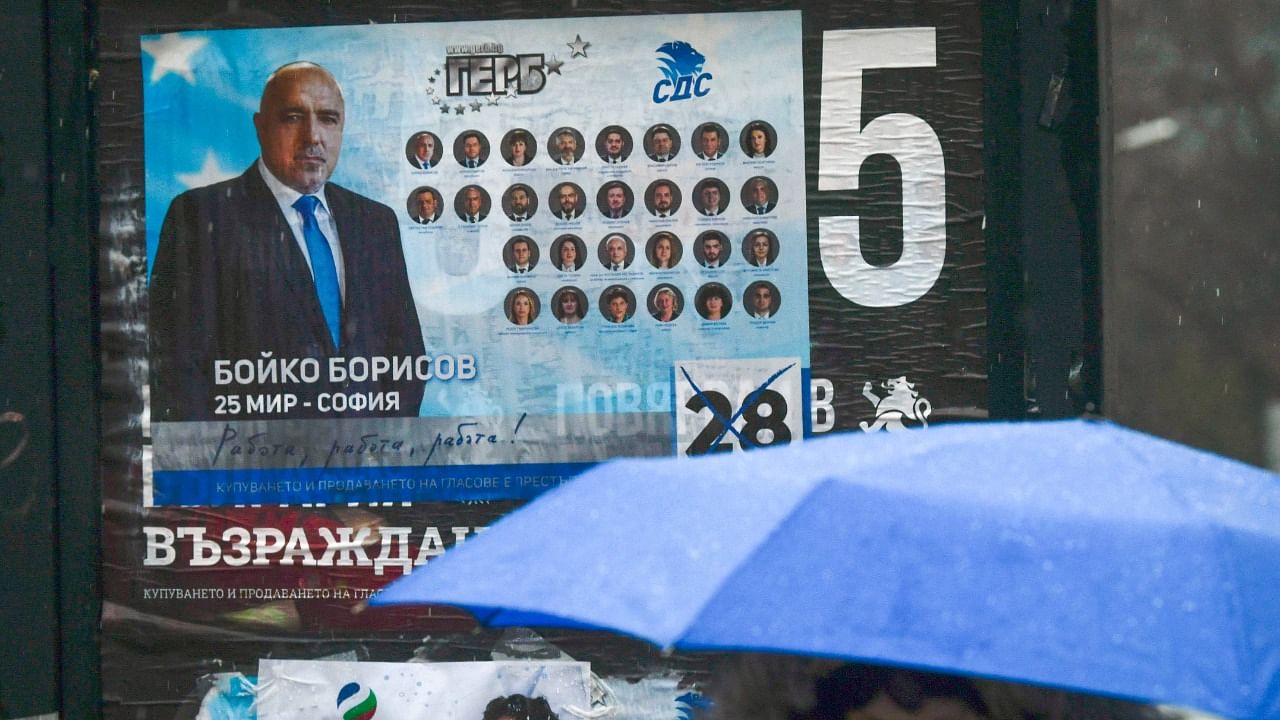 A woman walks past an election poster of Bulgaria's Prime Minister and leader of GERB party Boyko Borisov during the country's parliamentary election in Sofia. Credit: AFP.
