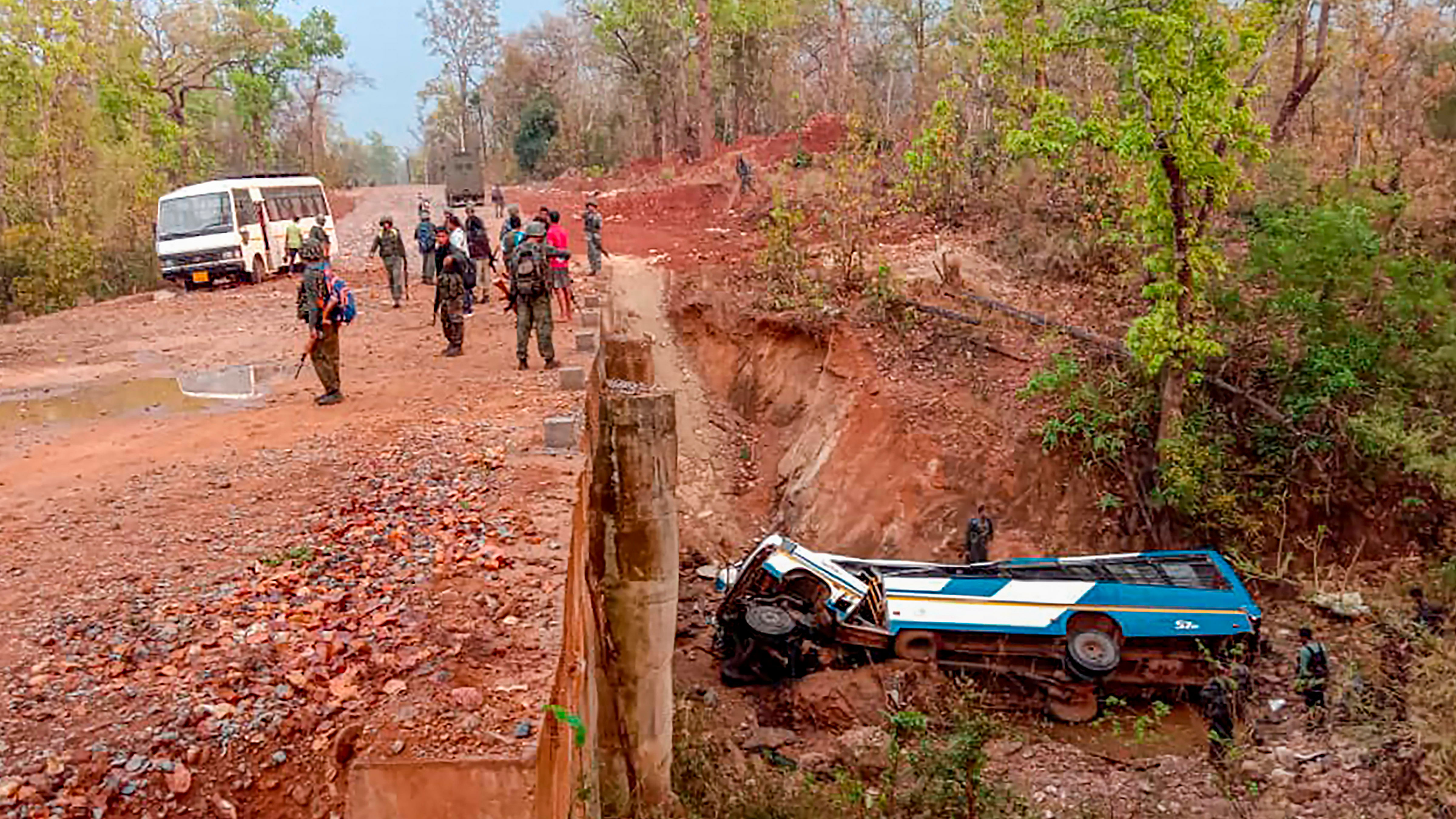 In this photo provided by the Indo Tibetan Border Police, security officers patrol the site of a bombing allegedly by Maoist rebels, killing atleast four policemen, in Narayanpur district of Chhattisgarh. Credit: PTI Photo