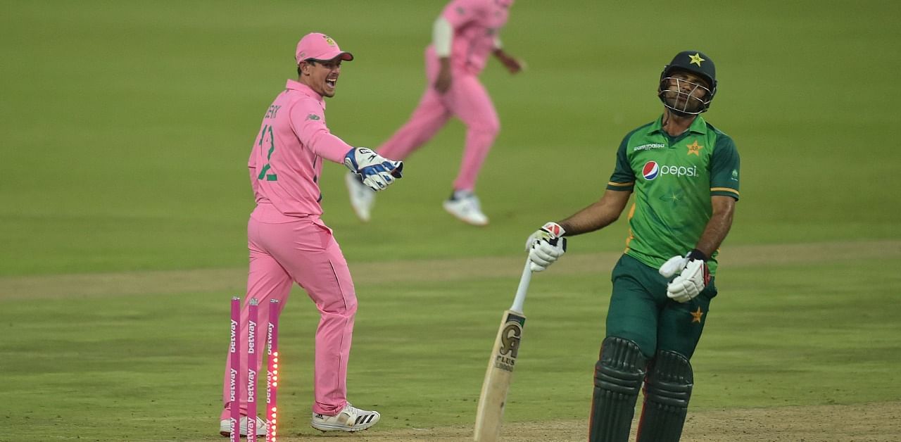 Zaman (R) reacts after being run out by de Kock. Credit: AFP Photo