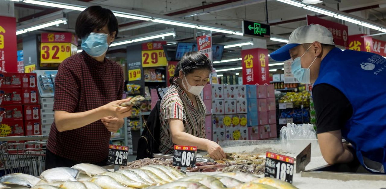 People look at fresh seafood in a supermarket following an outbreak of the coronavirus disease in Beijing. Credit: Reuters photo. 