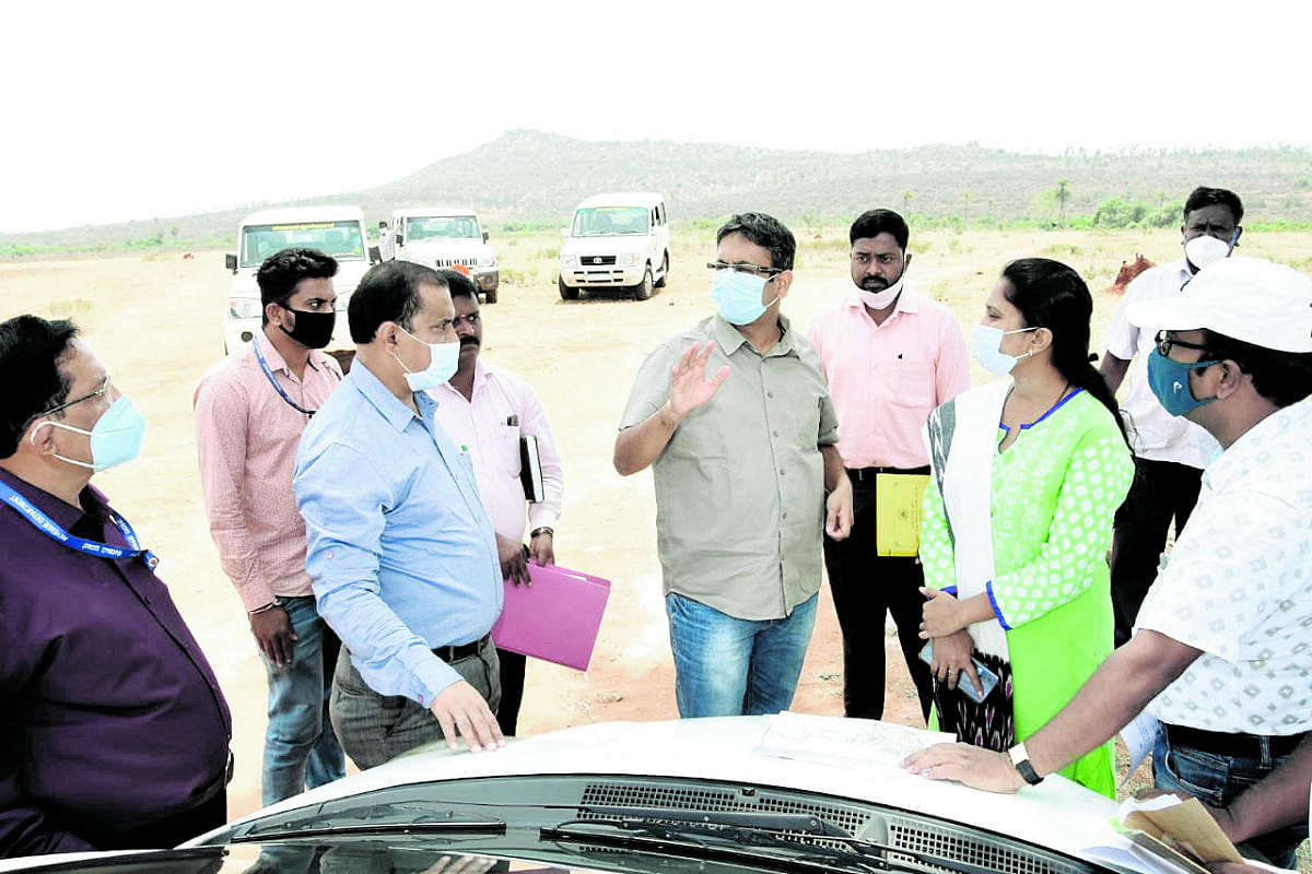 Commissioner for Information and Public Relations P S Harsha inspects the land identified for the proposed Film City at Himmavu at Nanjangud taluk in Mysuru district on Saturday. Credit: DH Photo
